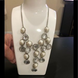 Costume jewelry silver necklace with pearl and glass accents.
